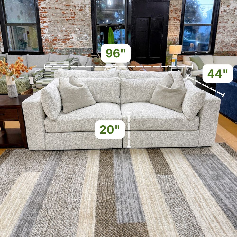 Alpine 2-piece sectional sofa by Ashley Furniture featuring plush cushions, neutral fabric upholstery, and modern design.