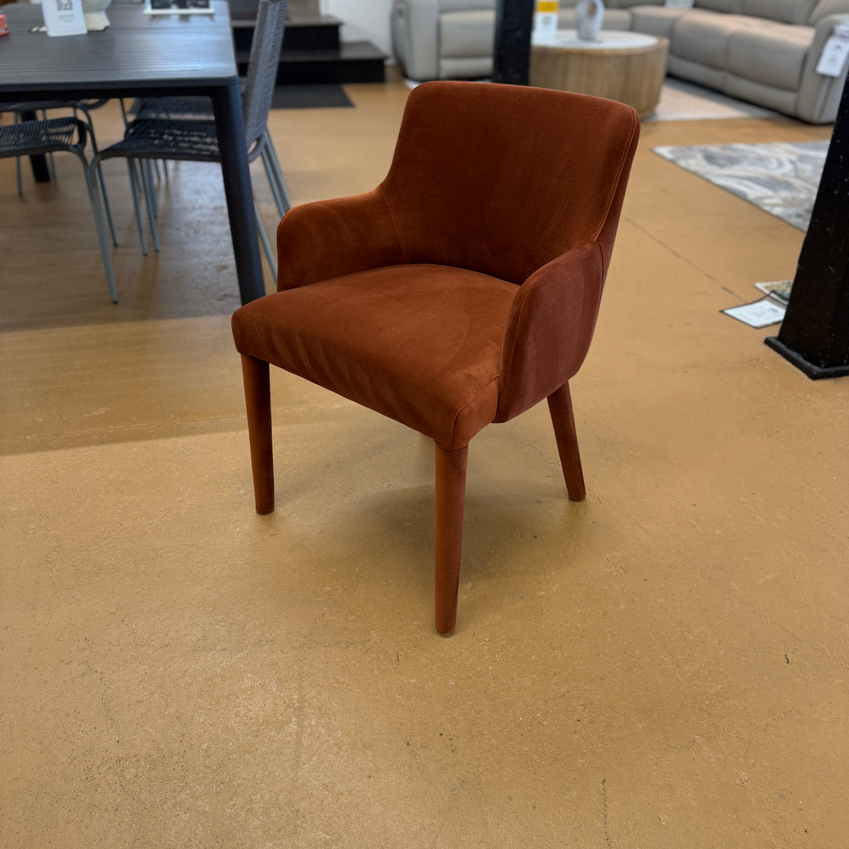 Rust velvet MCM-style armchair by Article with a sleek design, wooden legs, and plush cushioned seat.