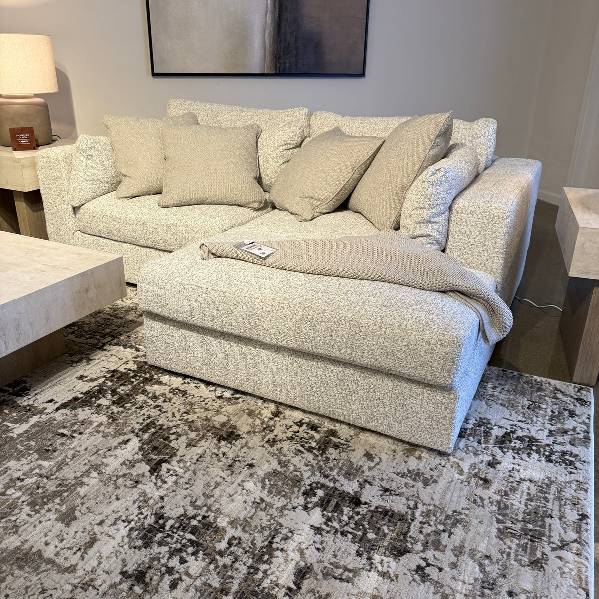 Ashley Furniture Alpine 2-piece sectional with chaise, featuring plush upholstery and modern design in a cozy living room setting.