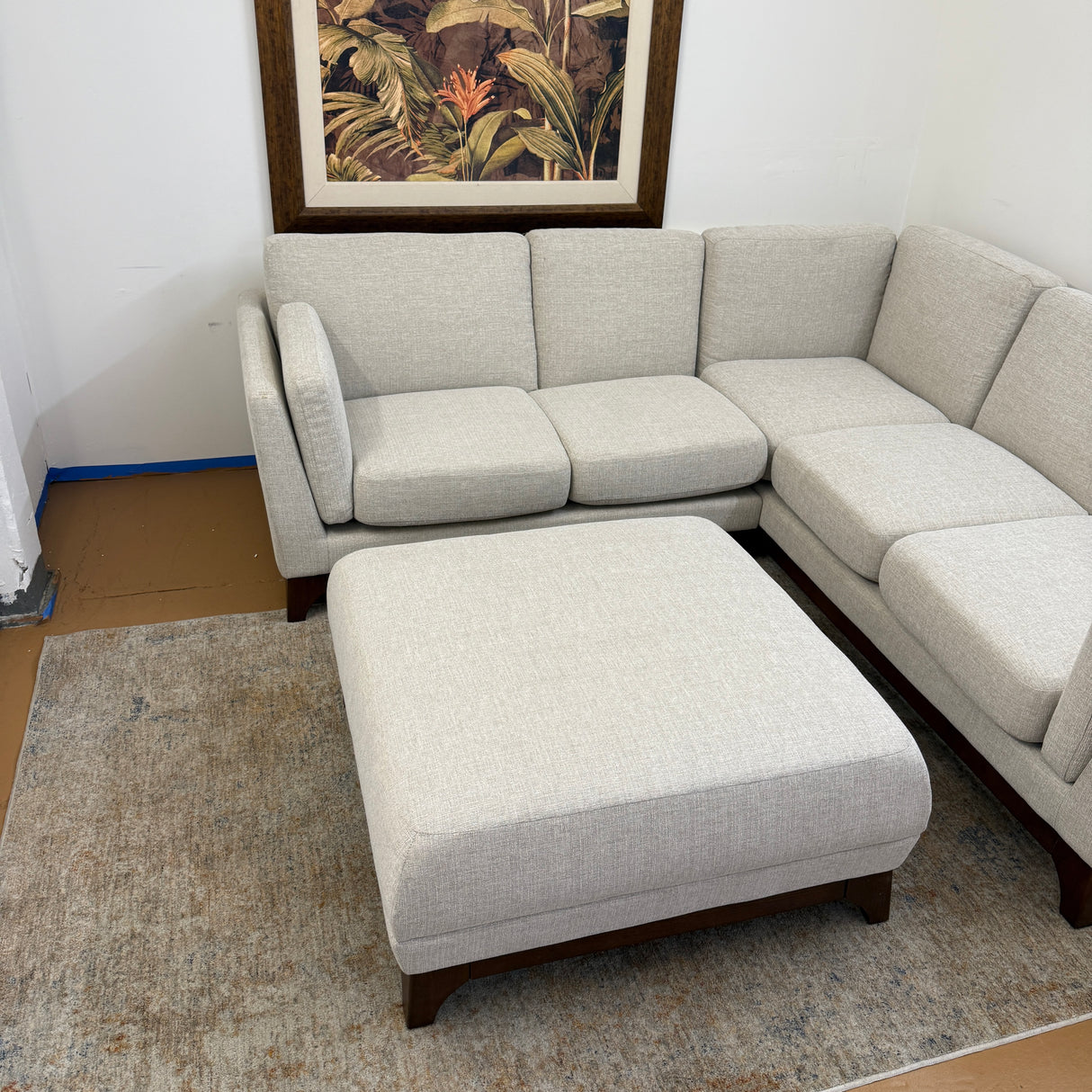 Chalk gray Article 88-inch corner sectional sofa with matching ottoman, modern design and walnut wood legs.