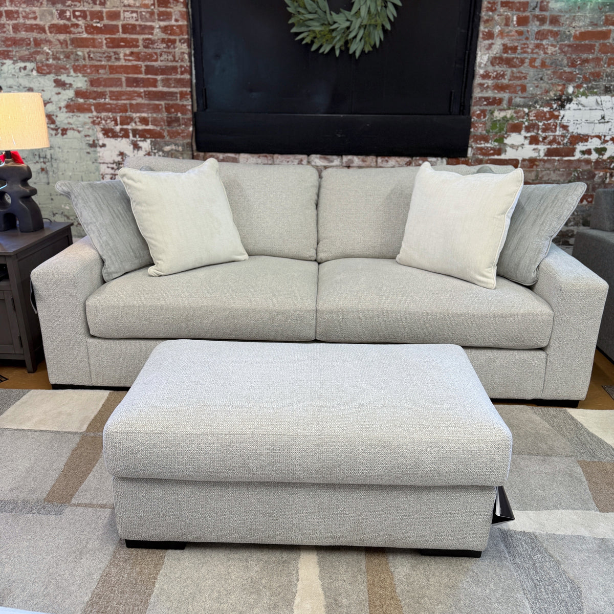 Ashley Furniture Hudson Sofa with plush cushions and contemporary design, featuring neutral fabric upholstery.