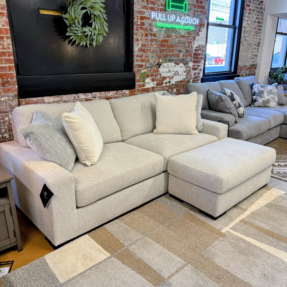 Ashley Furniture Hudson sofa with plush fabric and modern design, shown in a living room setting.
