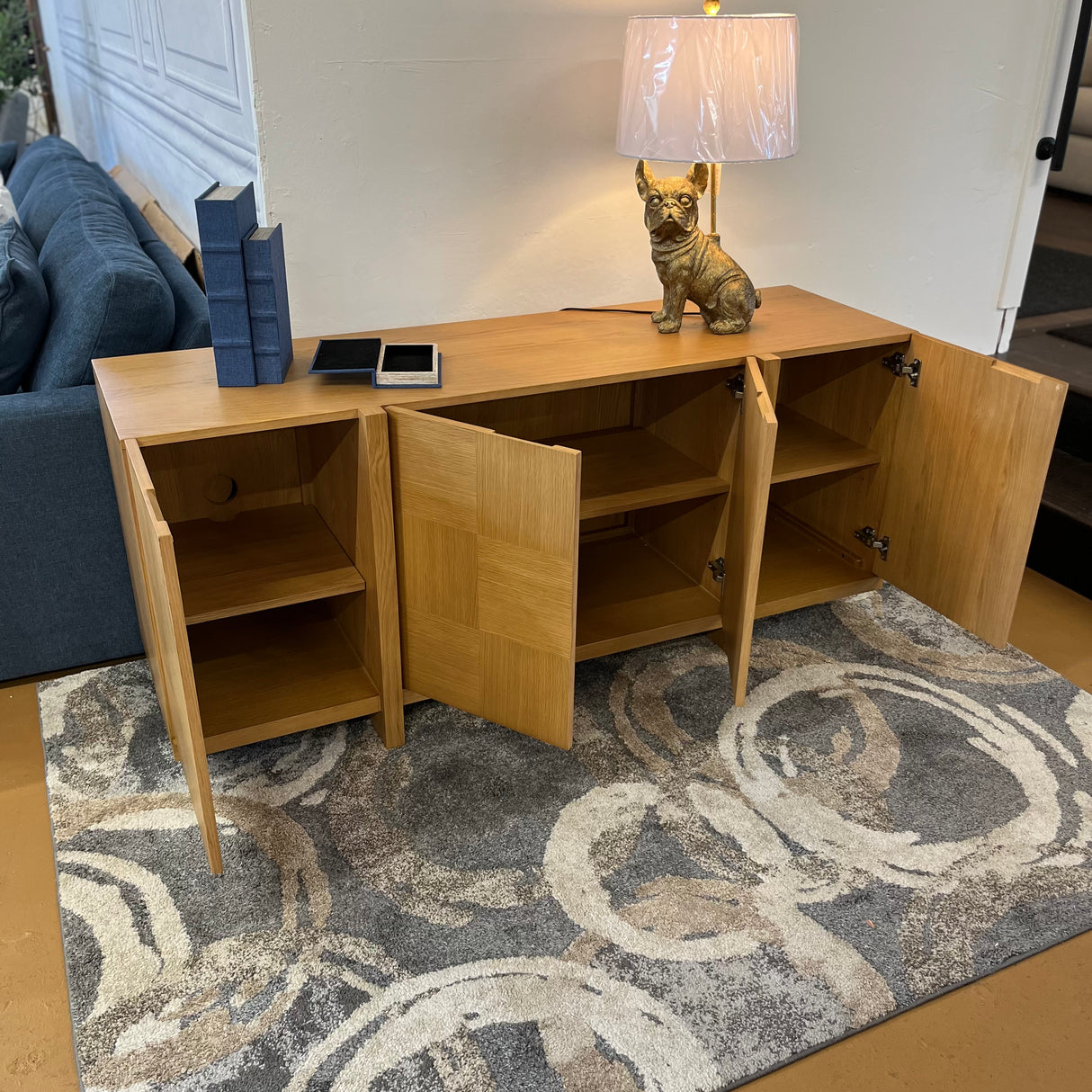 Natural oak MCM-style sideboard measuring 66 inches, sleek design, with doors and storage space, by Article.