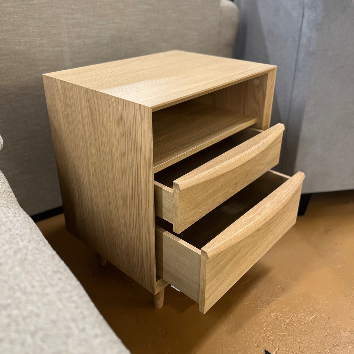White oak MCM-style nightstand with two drawers, modern design by Article, featuring sleek wood grain and minimalist hardware.