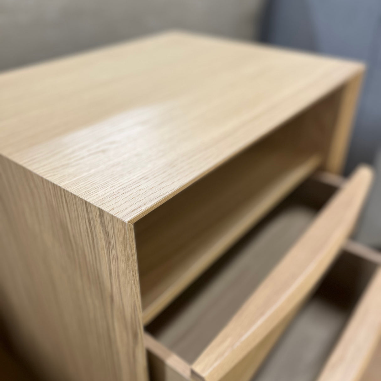 White oak MCM-style nightstand with two drawers, modern design, by Article, featuring sleek wood grain and minimalist hardware.
