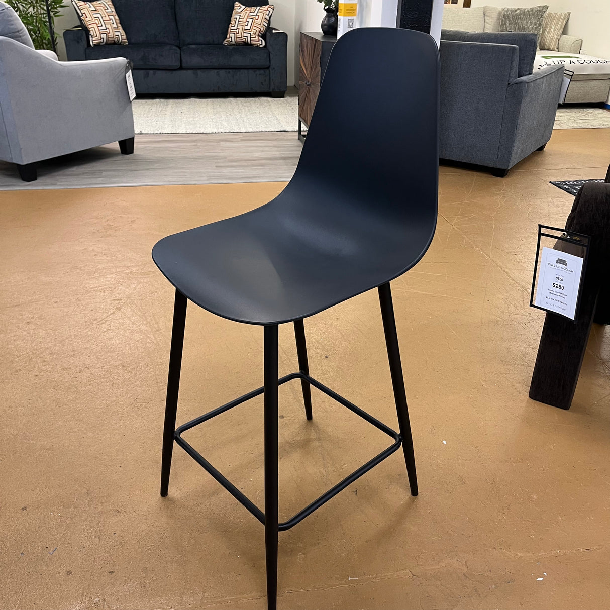 Black MCM barstool by Article with a sleek counter height design, featuring a modern minimalist style and sturdy wooden legs.