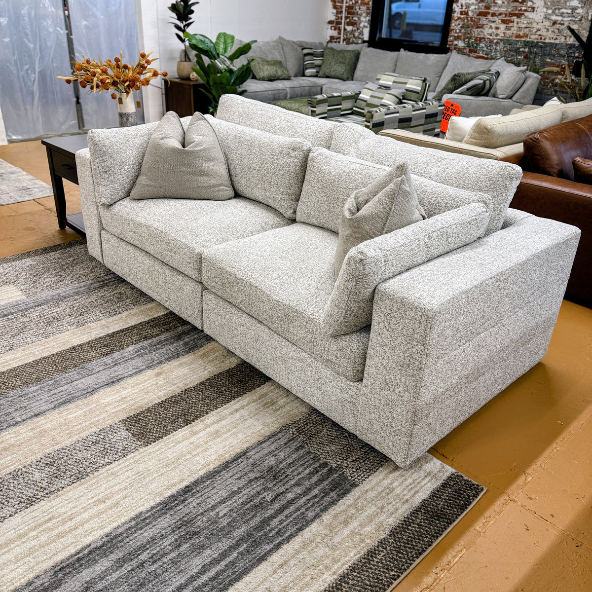 Ashley Furniture Alpine 2-piece sectional sofa with plush cushions and modern design, shown in a cozy living room setting.