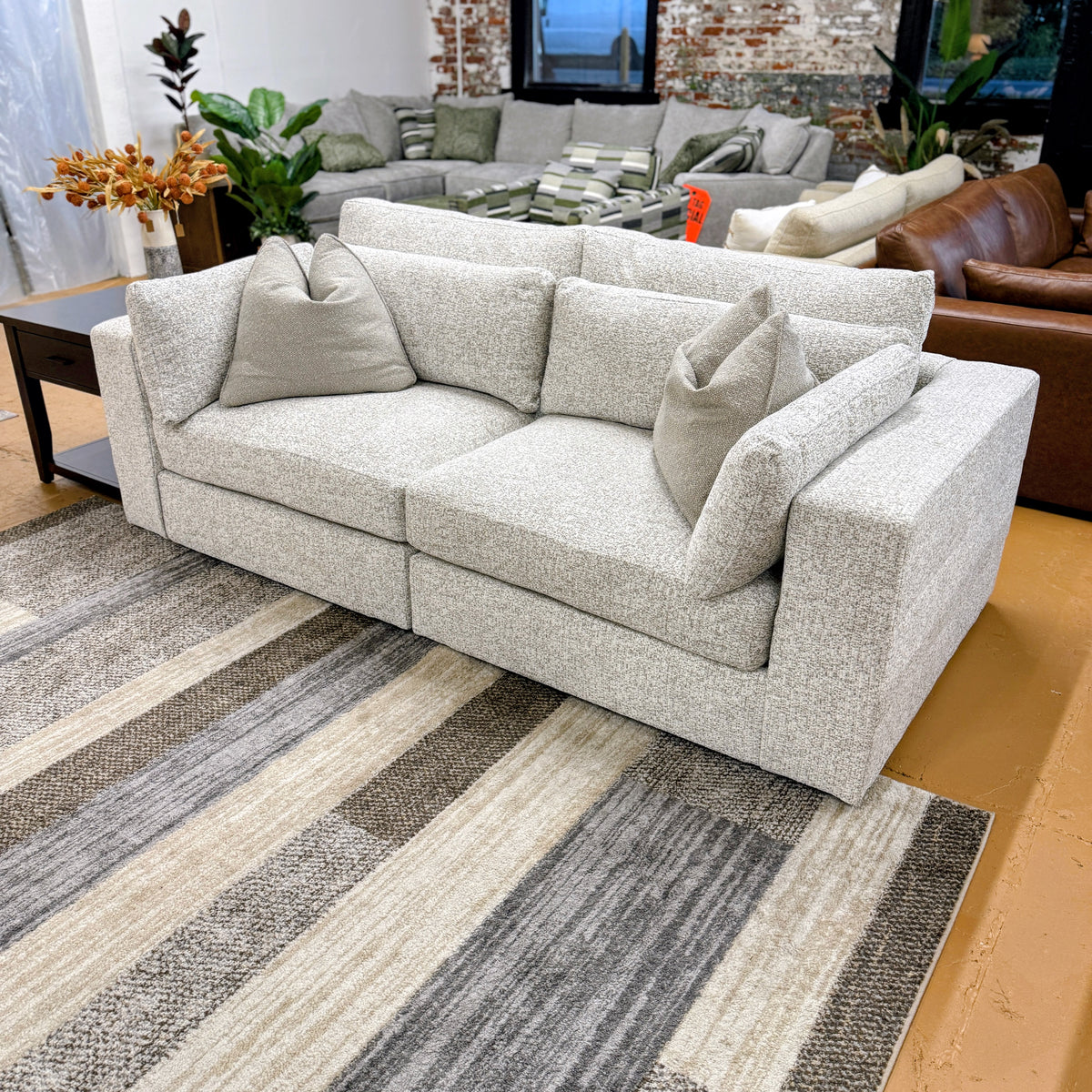 Alpine 2-piece sectional sofa by Ashley Furniture with plush cushions and modern design, shown in a cozy living room setting.