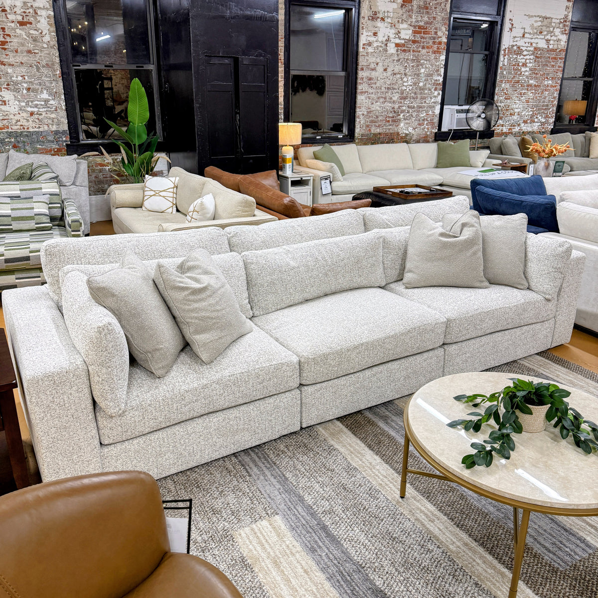 Alpine 3-piece sectional sofa by Ashley Furniture with plush cushions and modern design, shown in a cozy living room setting.