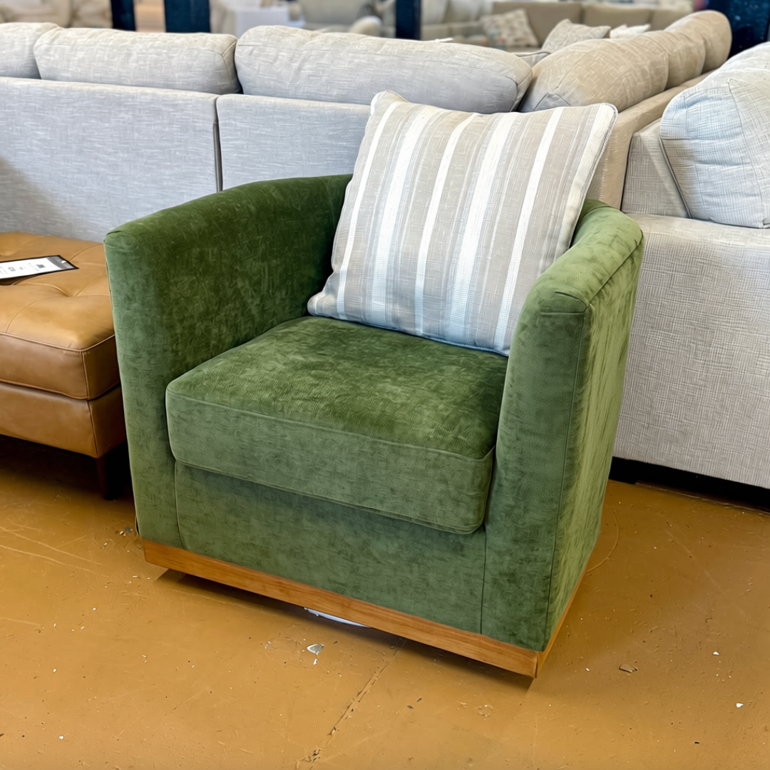 Ashley Furniture Jersonlow swivel chair with modern design, featuring a plush cushioned seat and sleek wooden legs.