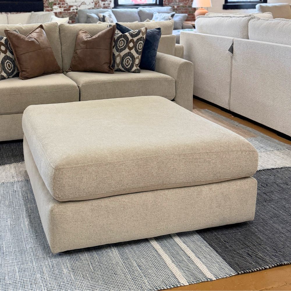 Behold Home Sequoia Accent Ottoman with wooden legs and plush fabric upholstery, ideal as a stylish footstool or side table.