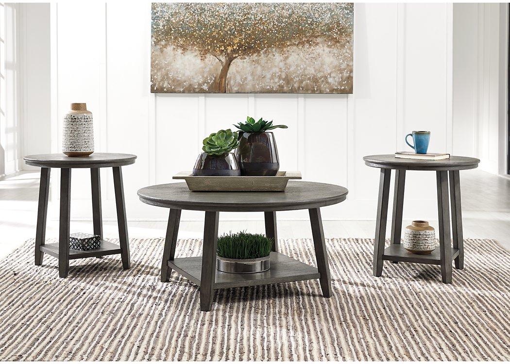 Set of three Ashley Furniture Caitbrook tables, featuring wooden tops and tapered legs, arranged together in a modern living room setting.