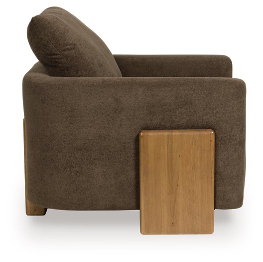 Ashley Furniture Dairlett Accent Chair with plush fabric and curved arms, showcased from a side angle.