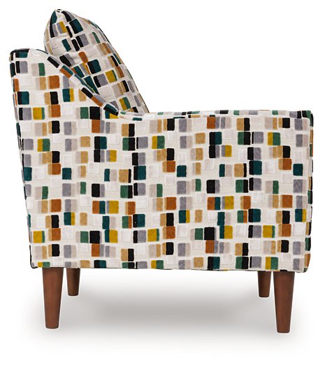 Ashley Furniture Fenna Accent Chair with wooden legs and plush upholstery, shown from the side.