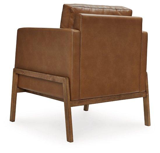 Ashley Furniture Numund accent chair with plush fabric and modern design, showcasing a comfortable and stylish seating option.