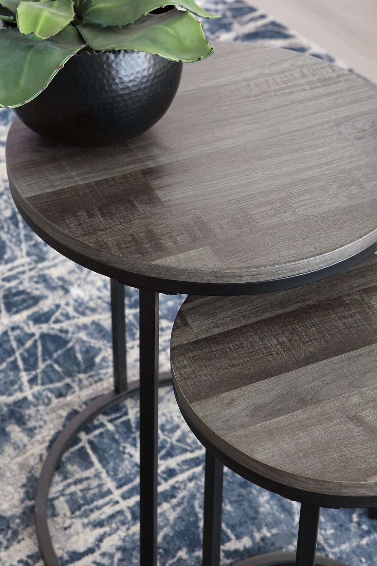 Set of two Ashley Furniture Briarsboro accent tables with wooden tops and tapered legs, ideal for living room decor.