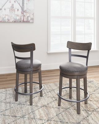 Ashley Furniture Caitbrook counter height bar stool with wooden legs and upholstered seat, shown in a modern kitchen setting.