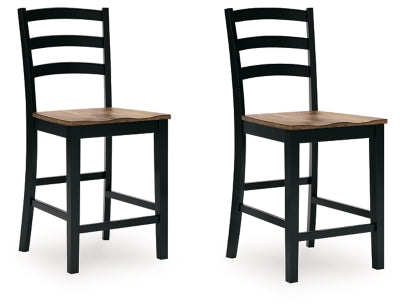 Ashley Furniture Wildenauer counter height barstool with wooden legs and a cushioned seat, shown from an angled side view.