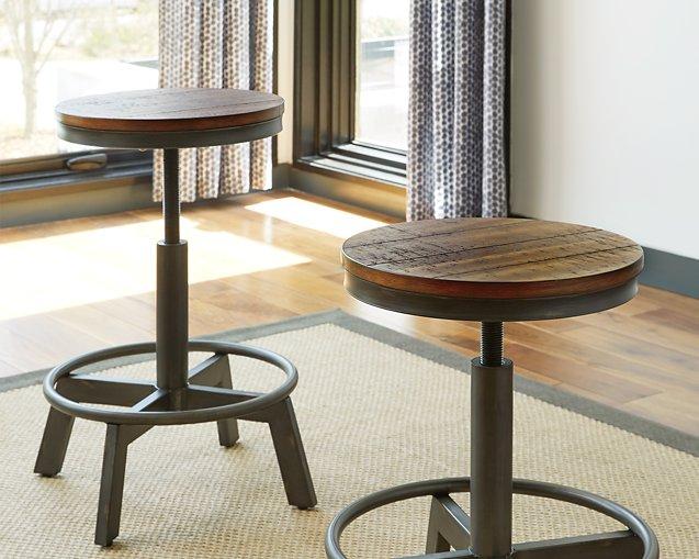 Set of Ashley Furniture Torjin Bar Stools with wooden seats and metal legs, arranged around a kitchen island.