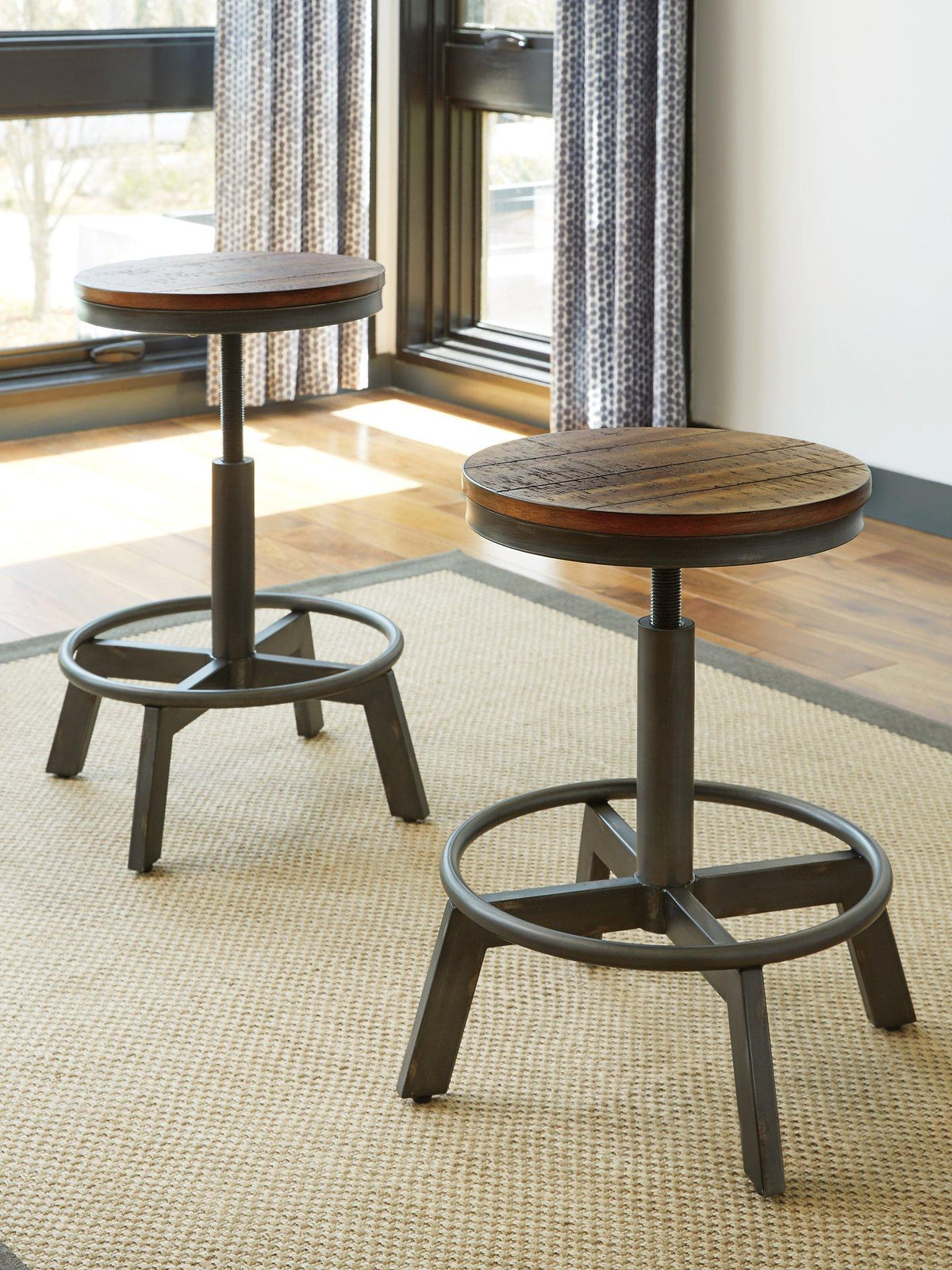 Set of four Ashley Furniture Torjin barstools with wooden legs and cushioned seats, arranged around a modern kitchen island.