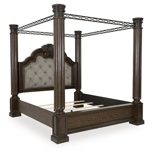 Ashley Furniture Maylee Bed with a sleek upholstered headboard and wooden frame, shown from an angled side view.