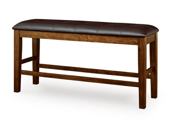 Ashley Furniture Ralene counter height dining bench with wood finish and upholstered seat, angled view showing sturdy design.