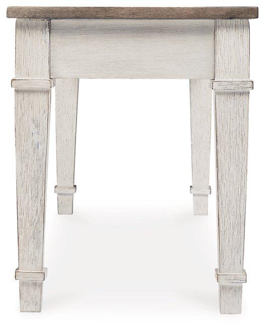 Ashley Furniture Skempton Storage Bench with cushioned top and wooden legs, ideal for entryways and living rooms.