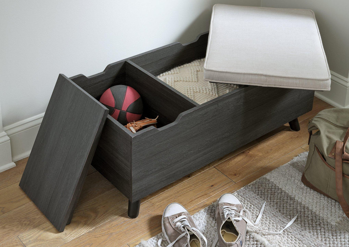 Yarlow Storage Bench by Ashley Furniture featuring a wood finish, cushioned top, and built-in storage compartment.