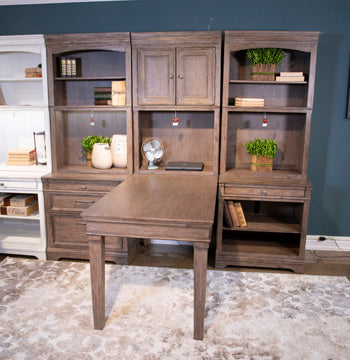 Ashley Furniture Janismore Bookcase with open shelves and storage compartments in a modern wood finish.