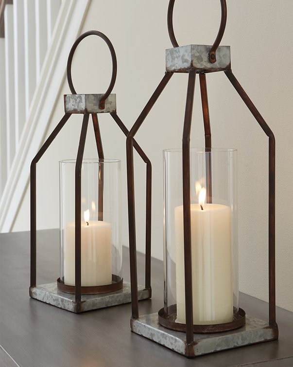 Two Diedrick Lantern candle holders by Ashley Furniture with metal frames and glass panels, suitable for decorative lighting.