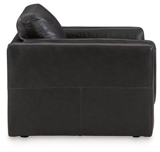 A large Amiata oversized chair by Ashley Furniture with plush fabric and wide armrests, ideal for a cozy living room seating area.