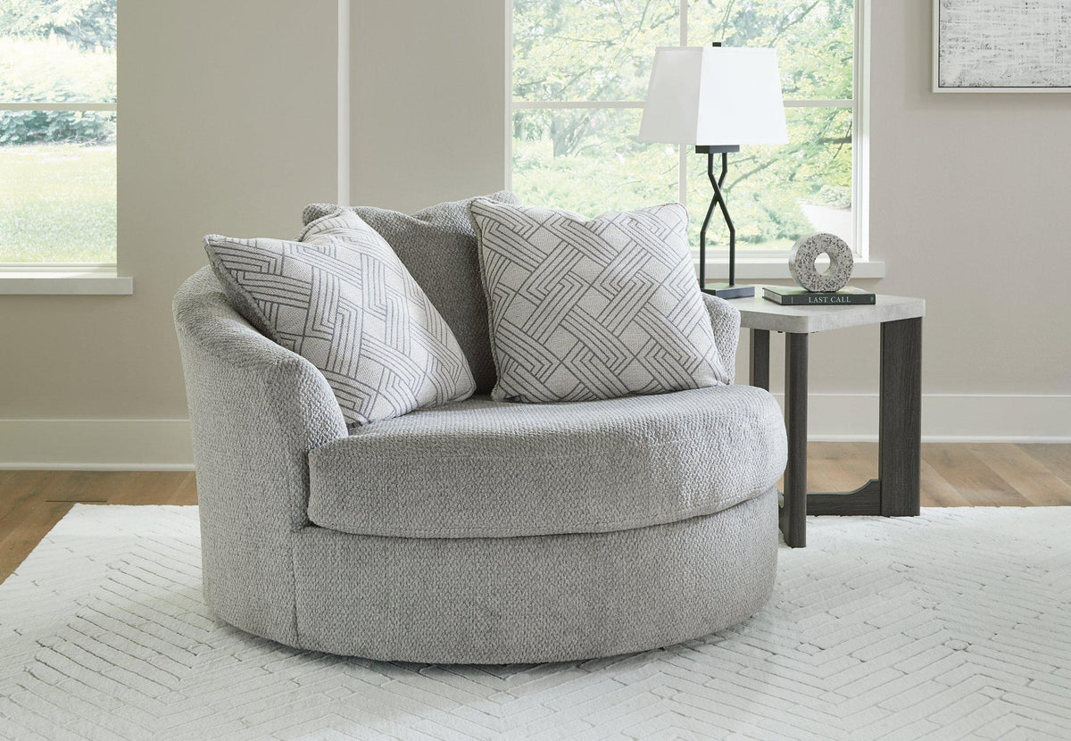 Oversized Ashley Furniture Casselbury swivel accent chair with plush fabric and rounded armrests, perfect for stylish living spaces.
