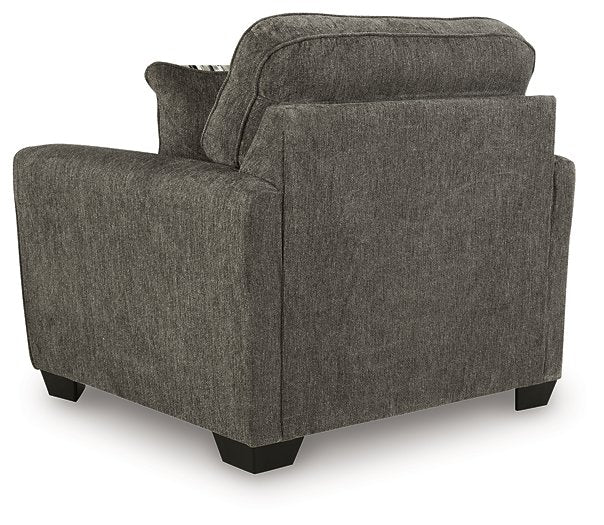Ashley Furniture Olten oversized chair with plush fabric, wide armrests, and a comfortable backrest in a modern living room setting.