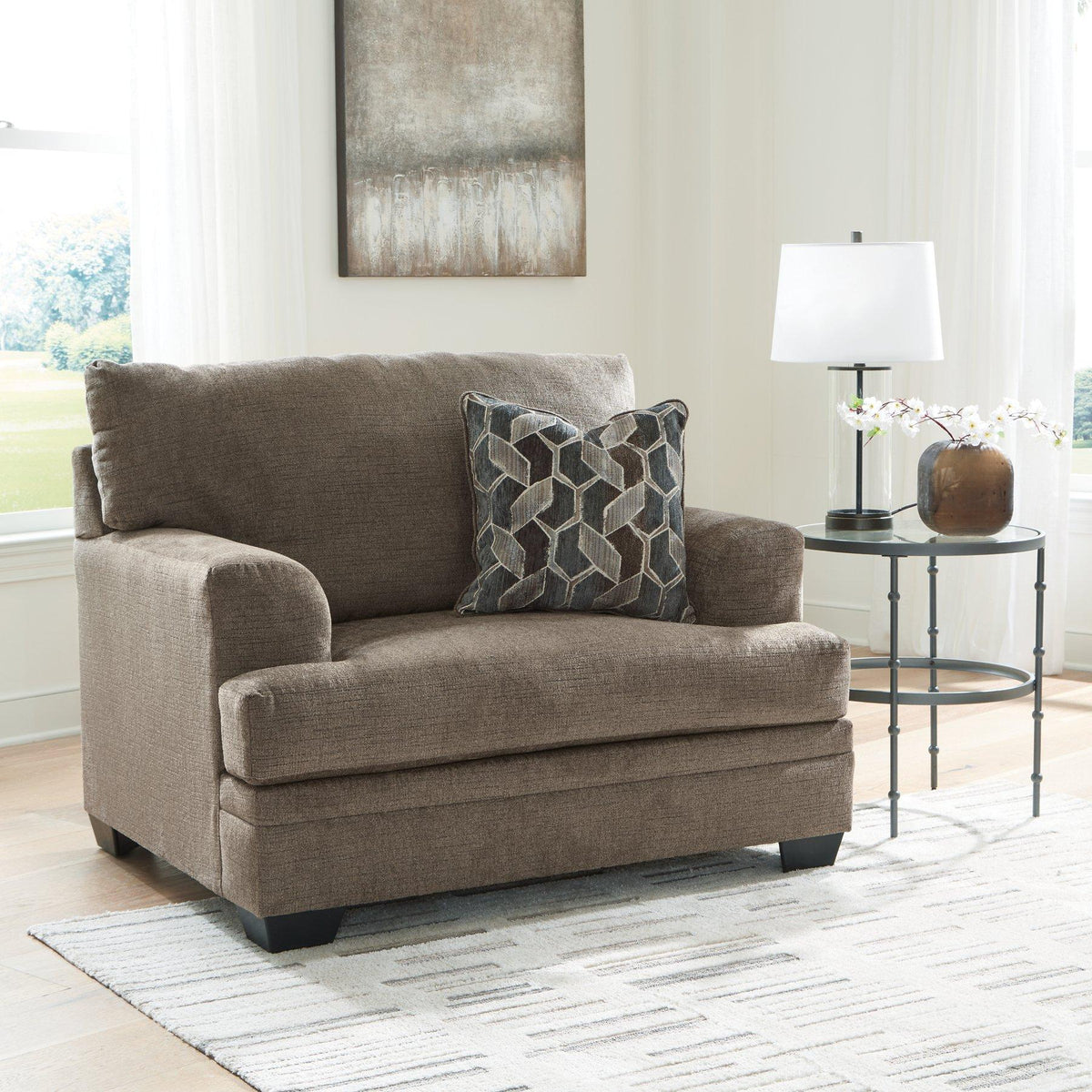 Oversized chair by Ashley Furniture with plush cushions and modern design, perfect for living room relaxation.