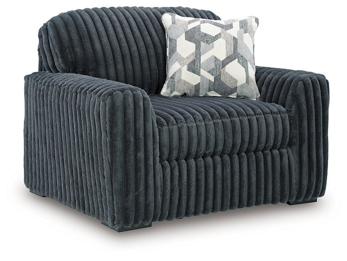 Ashley Furniture Midnight Madness oversized chair with plush fabric and wide armrests, shown from an angled side view.