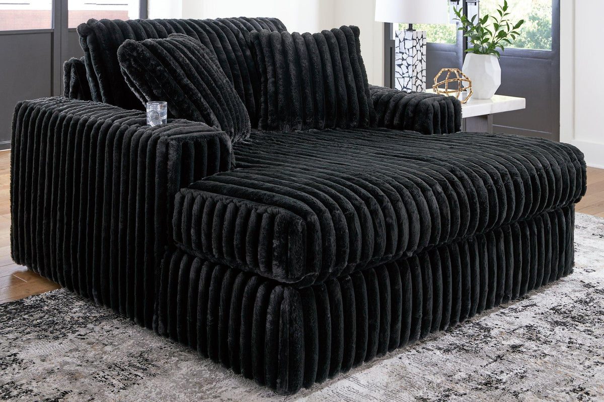 Oversized Midnight-Madness Ashley Furniture chaise lounge with plush fabric and modern design, perfect for relaxing in style.