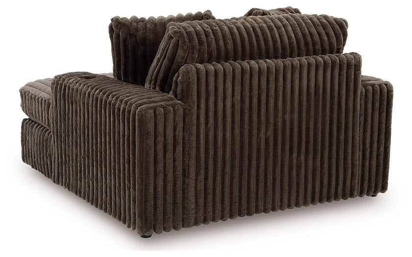 Ashley Furniture Midnight-Madness oversized chaise chair with plush upholstery and a modern design, shown from the back.