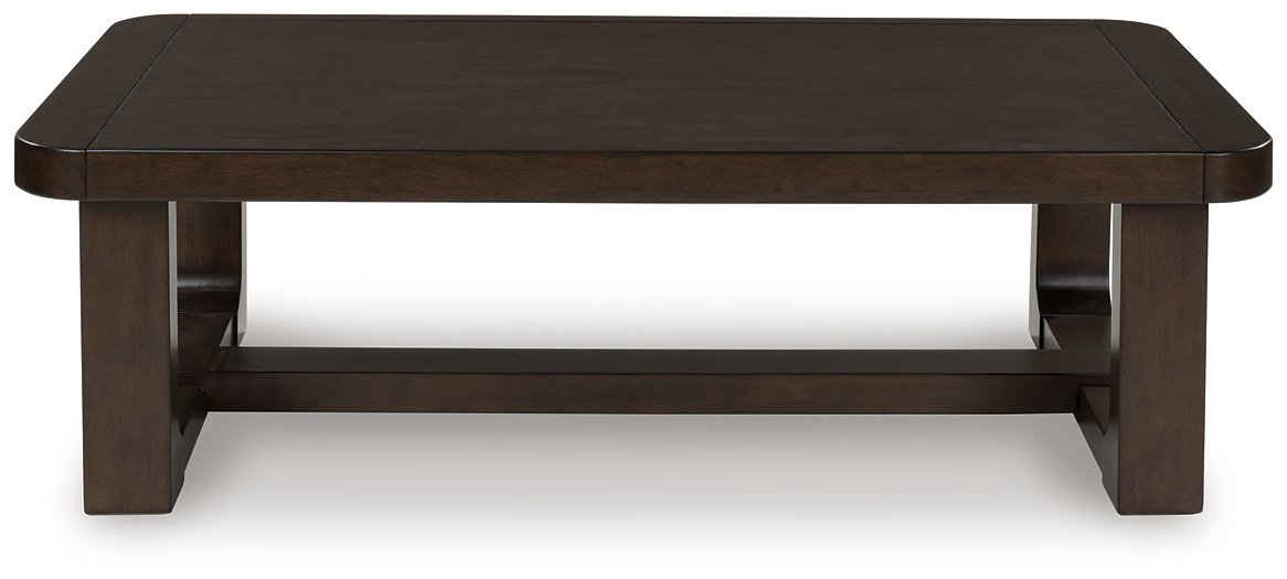 Ashley Furniture Breckington coffee table with a wooden top and metal legs, showcasing a modern cocktail table design.