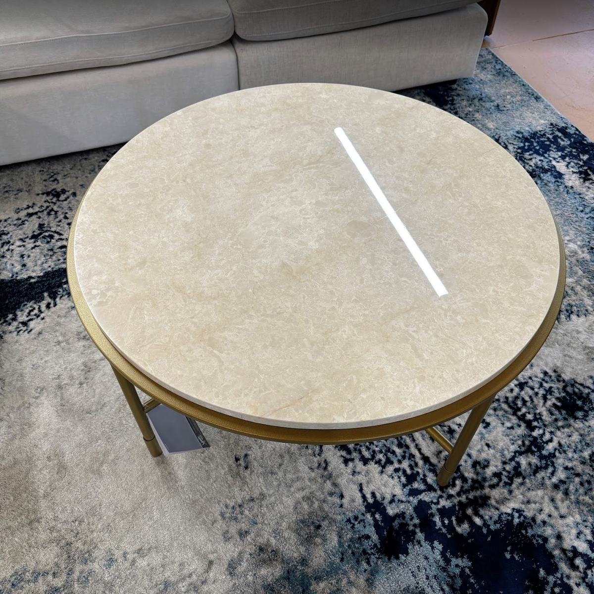 Ashley Furniture Alder coffee table, modern cocktail table with a sleek finish and sturdy wooden legs, ideal for living room decor.