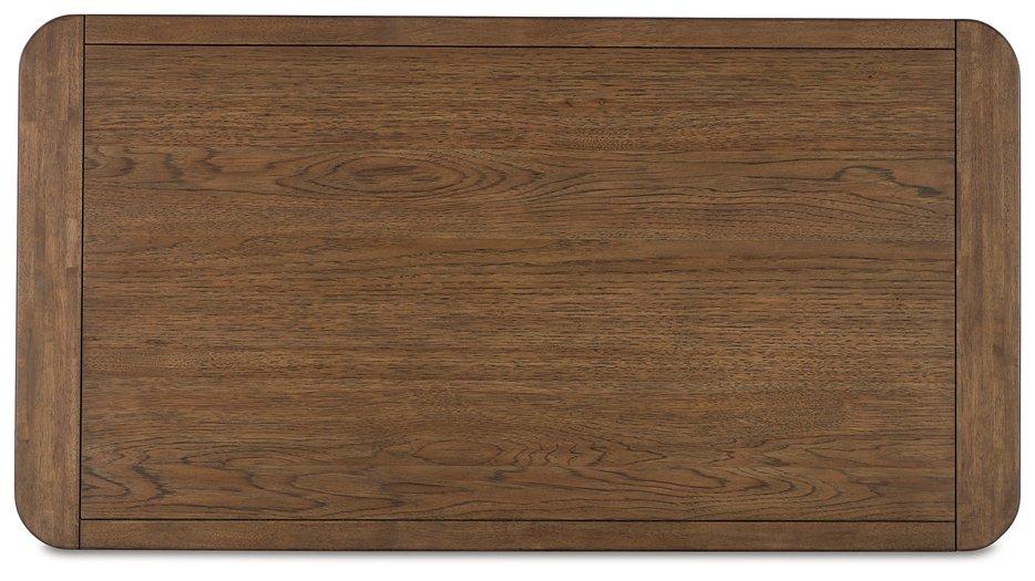 Cabalynn cocktail coffee table by Ashley Furniture with a sleek wooden surface and modern design for living room decor.