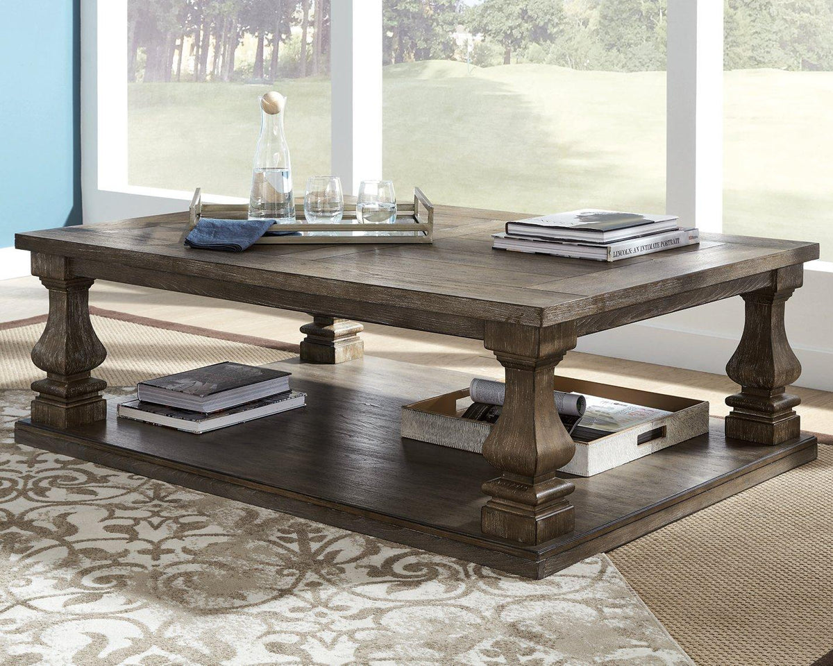 Ashley Johnelle coffee cocktail table with a sleek wooden top and modern design, perfect for living room décor.
