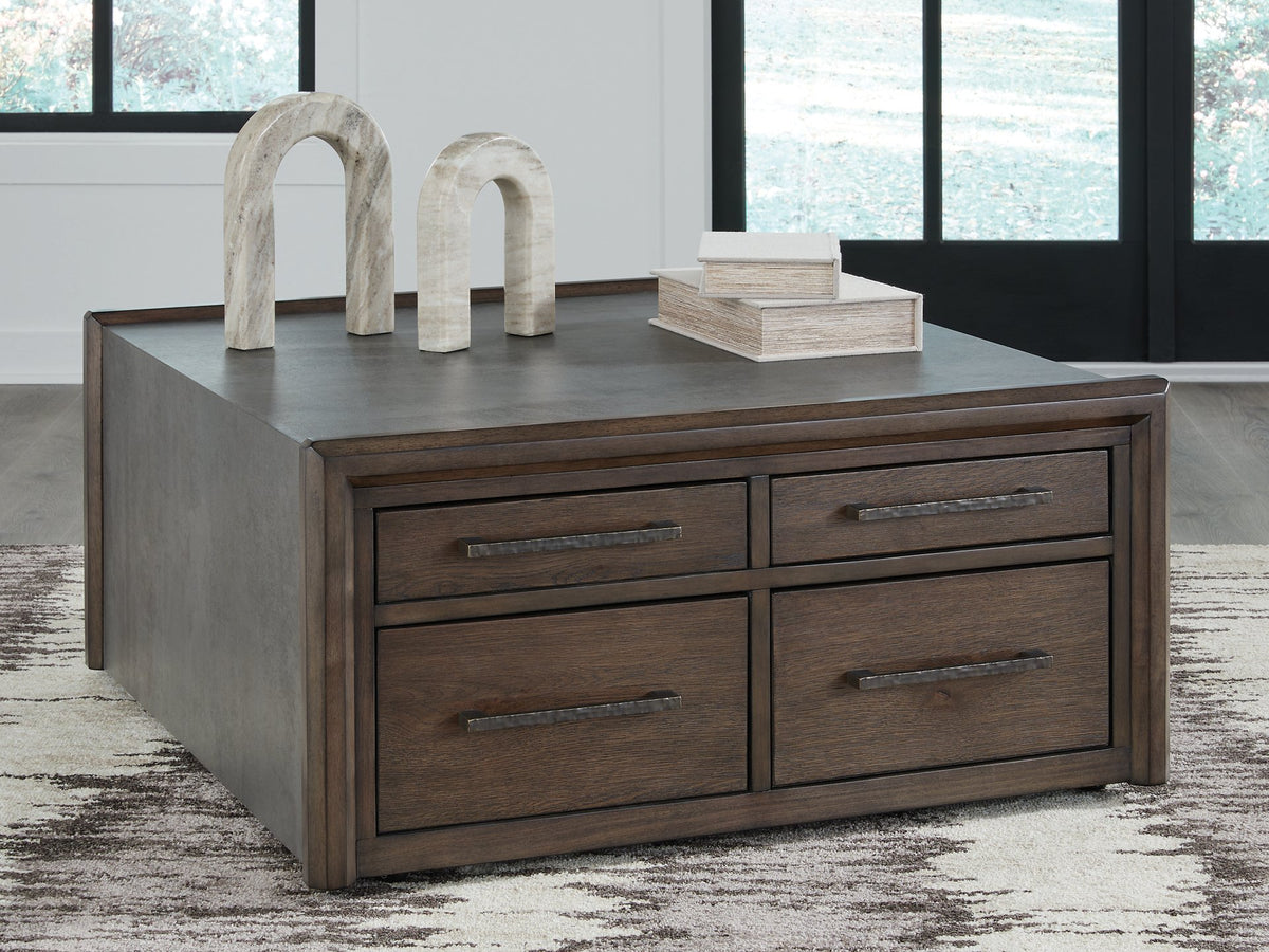 Ashley Furniture Kallenny coffee cocktail table with a rectangular wooden top and sturdy legs, shown in a close-up view.