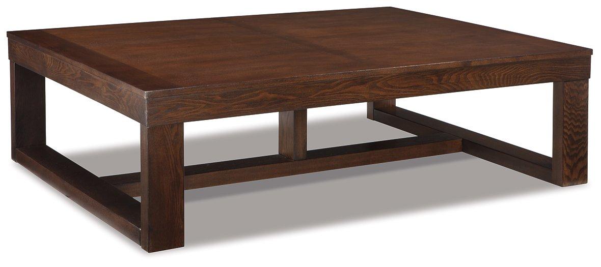 Ashley Watson cocktail coffee table with a wooden finish, modern design, and sturdy legs, ideal for living room decor.
