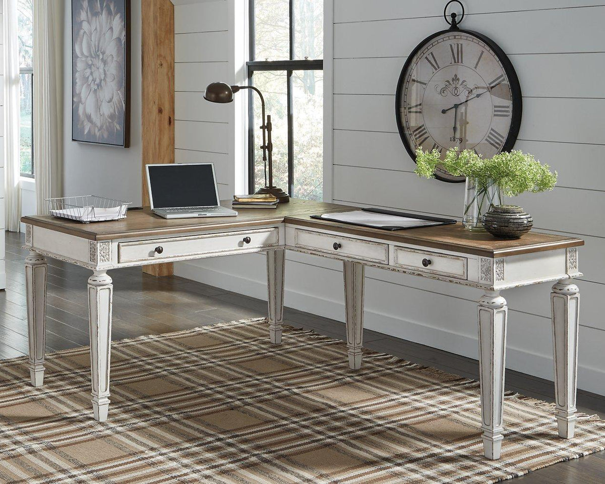 Realyn 2-piece home office lift top desk by Ashley Furniture showing the dark wood finish and lift-up tabletop for workspace.