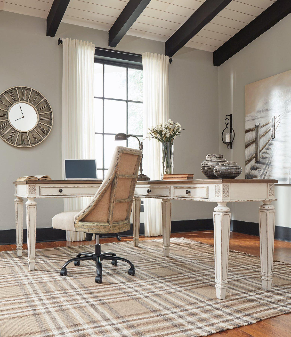 Realyn 2-piece home office lift top desk by Ashley Furniture showing the dark wood finish and spacious work surface with storage compartments.
