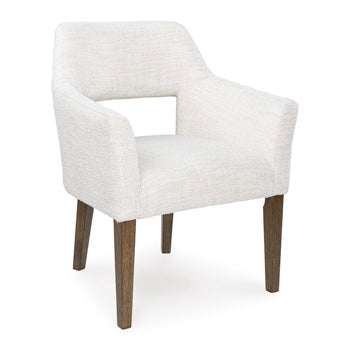 Ashley Furniture Marxmore dining arm chair with upholstered seat and wooden frame, shown from an angled view.