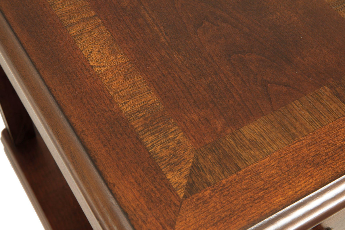 Ashley Furniture Breegin chairside end table with a wood finish, featuring a compact design and a sturdy top surface.