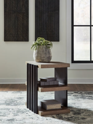 Ashley Furniture Rylandyn end table with a sleek wooden top and modern design, shown in a close-up shot.