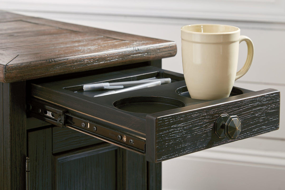Ashley Furniture Tyler Creek end table with USB ports and outlets, featuring a wooden surface and storage space.