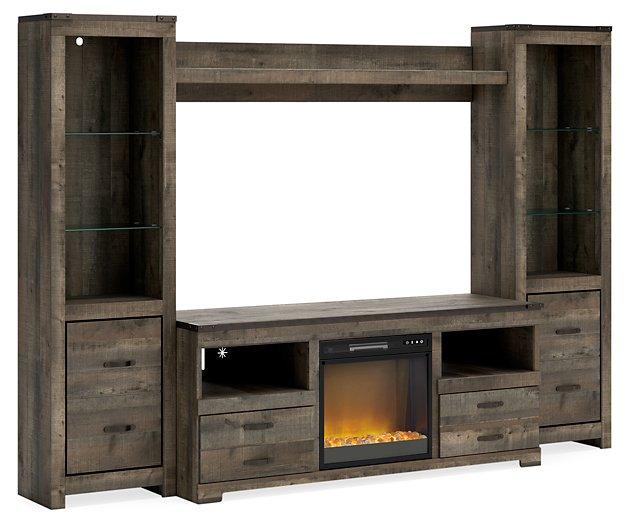 Ashley Trinell 4-piece entertainment center with electric fireplace, featuring shelves, cabinets, and a cozy built-in fireplace.